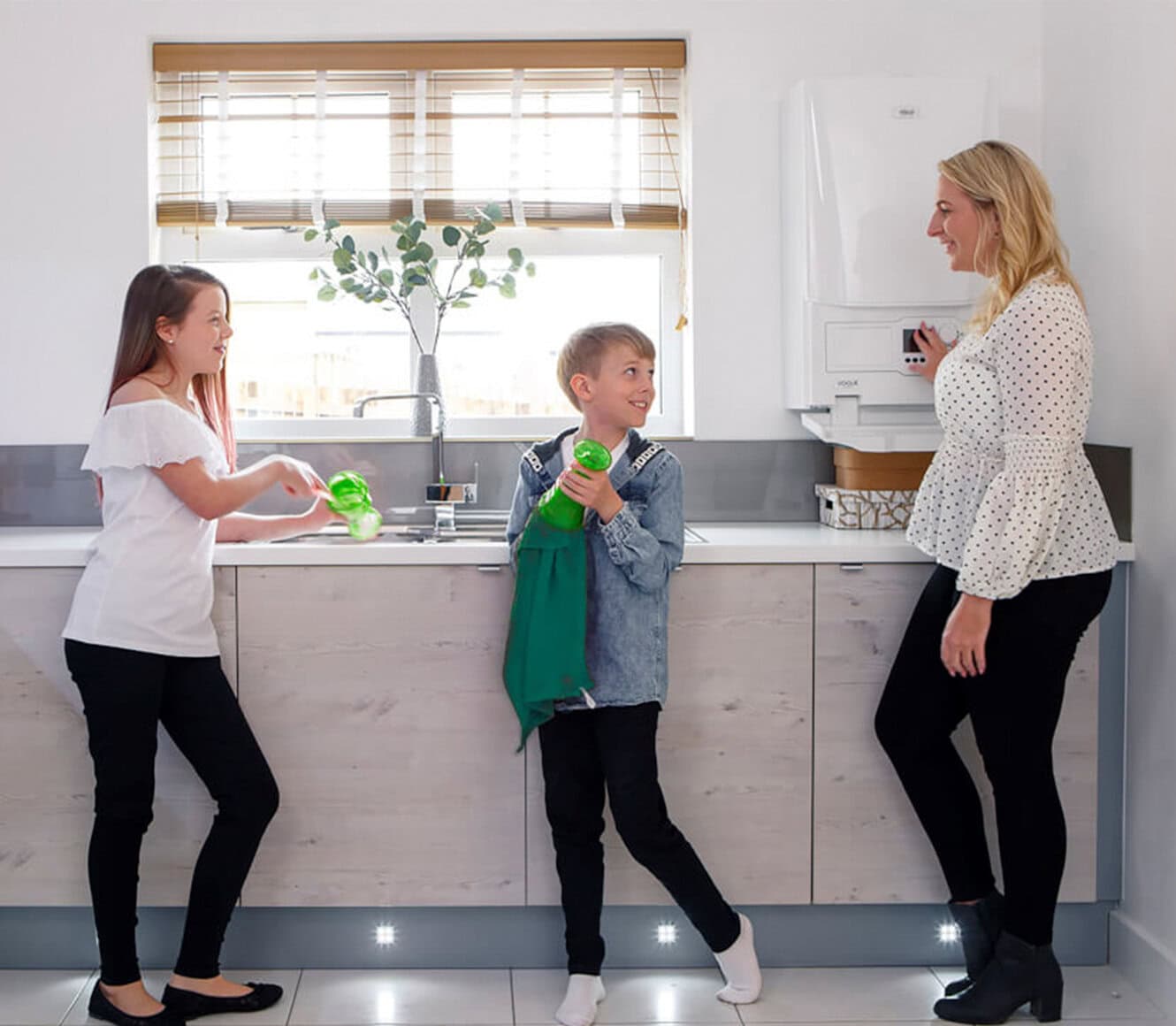 Family in a kitchen with a combi boiler installed